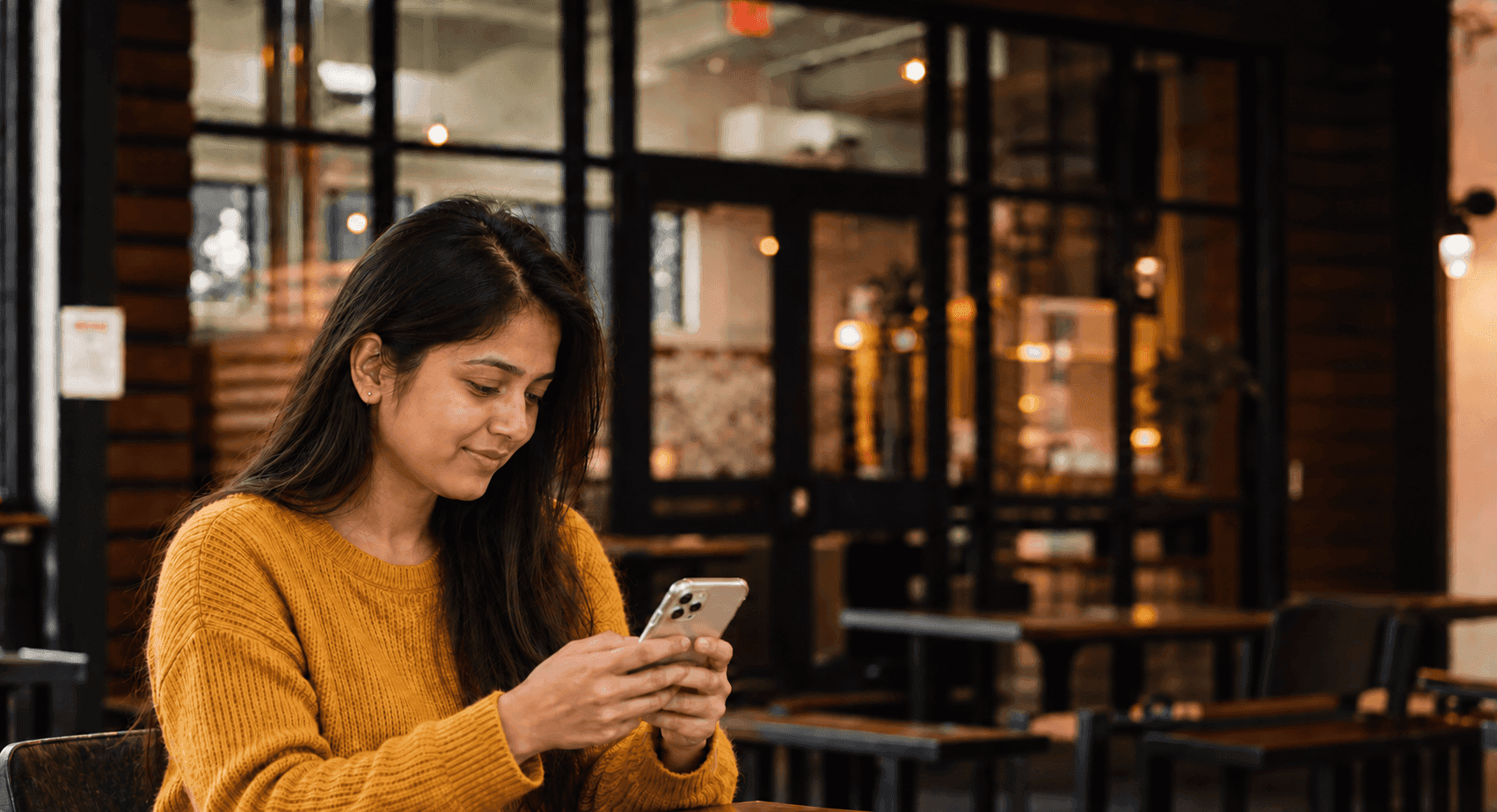 Young woman smiling at her phone