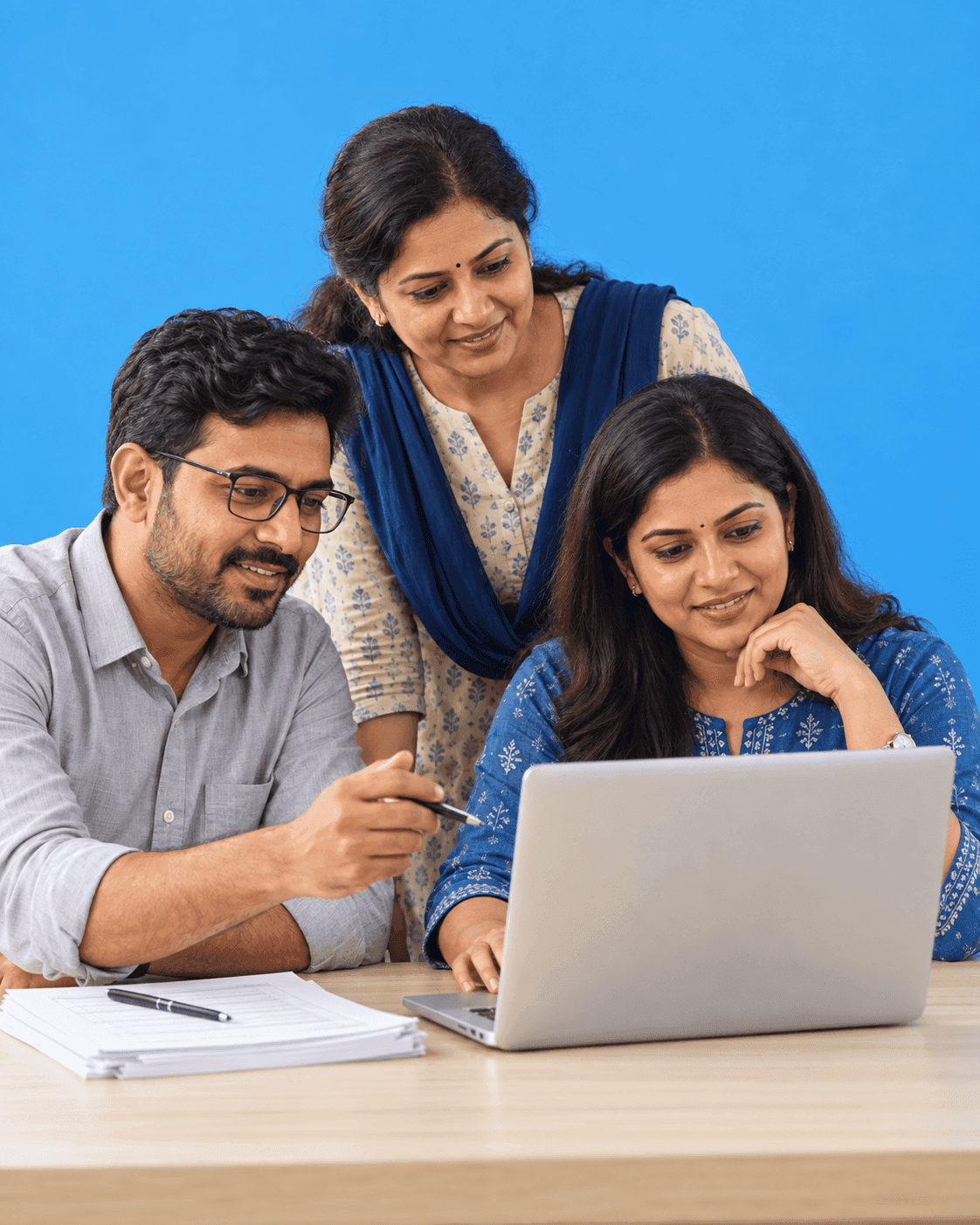 Teacher and colleague reviewing work on a laptop