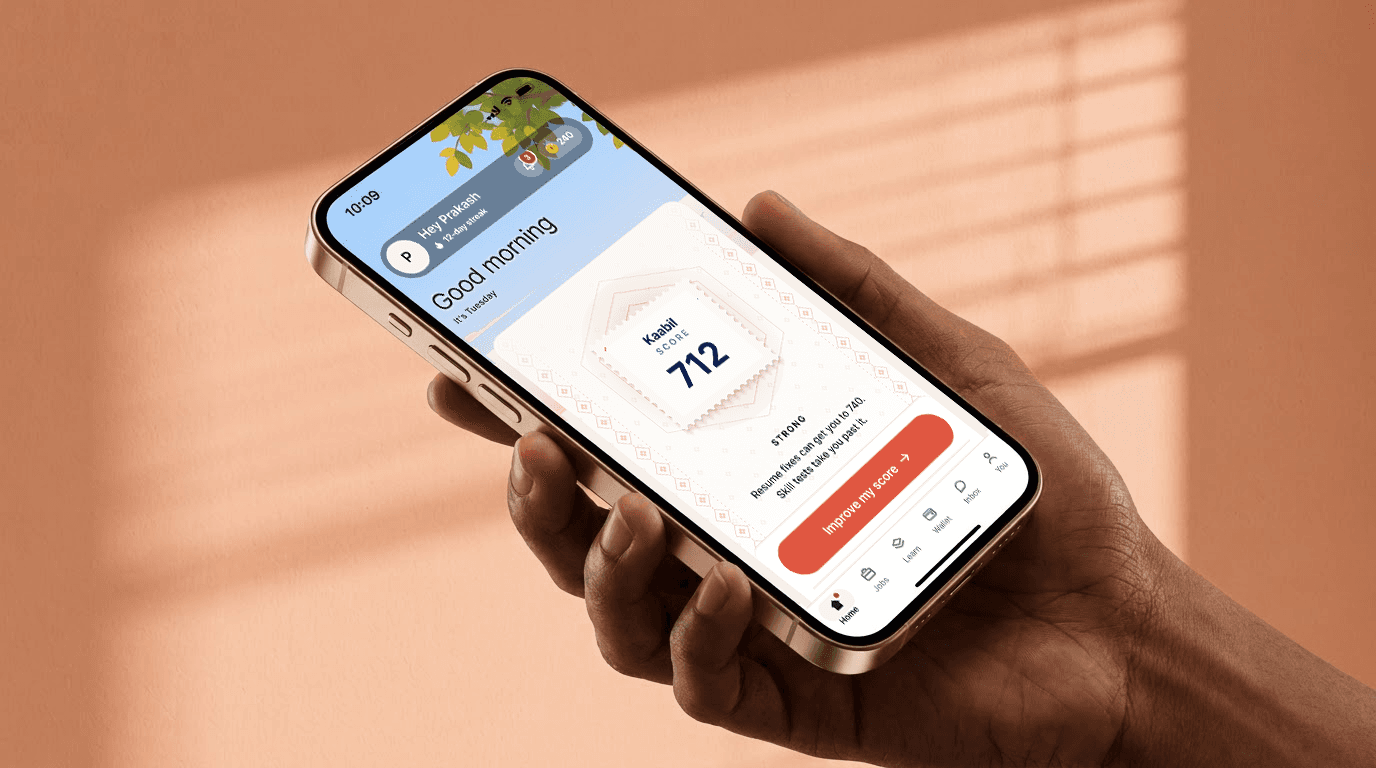 Candidate holding a phone showing a Kaabil score